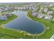 An aerial view of homes backing on the large pond that is the centerpiece for this community at 755 Canberra Blvd, Westfield, IN 46074