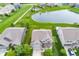 An aerial view of a beautiful two-story home by a pond with a well-maintained yard and driveway at 755 Canberra Blvd, Westfield, IN 46074