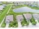 An aerial view of a beautiful two-story home by a pond with a well-maintained yard and driveway at 755 Canberra Blvd, Westfield, IN 46074