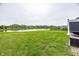 The large back yard features a community lake, fence and covered patio at 755 Canberra Blvd, Westfield, IN 46074