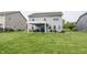 Expansive back yard with covered patio, barbeque, seating area and view of the lake at 755 Canberra Blvd, Westfield, IN 46074