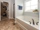 Bright bathroom features a soaking tub, a shower, and a view to a walk-in closet at 755 Canberra Blvd, Westfield, IN 46074