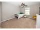 Cozy bedroom with neutral walls, carpet, a ceiling fan, and a bright sunny window at 755 Canberra Blvd, Westfield, IN 46074