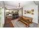 Bright dining area with rustic wooden table and adjacent kitchen with stainless appliances at 755 Canberra Blvd, Westfield, IN 46074