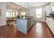 Modern kitchen with island and barstool seating, opening to the dining area with ample natural light at 755 Canberra Blvd, Westfield, IN 46074