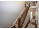 Carpeted staircase features wood and decorative metal railings, connecting the home's multiple levels at 755 Canberra Blvd, Westfield, IN 46074