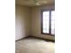 A bright bedroom with a large window allowing natural light to fill the carpeted space at 7622 Eaker Ct, Brownsburg, IN 46112