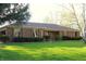 Charming single-story brick home with a well-manicured lawn and mature trees at 7622 Eaker Ct, Brownsburg, IN 46112