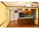 A view of the kitchen with modern appliances, wooden cabinets, and hardwood flooring at 7622 Eaker Ct, Brownsburg, IN 46112