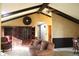 A cozy living room featuring a vaulted ceiling, wooden beams, decorative fireplace, and comfortable seating at 7622 Eaker Ct, Brownsburg, IN 46112
