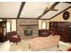 Cozy living room with a brick fireplace, comfortable seating, and classic decor at 7622 Eaker Ct, Brownsburg, IN 46112