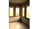 A sun room with tile floor and multiple windows offering natural light and views of the backyard at 7622 Eaker Ct, Brownsburg, IN 46112