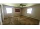 Vacant bedroom with ceiling fan, carpeted floors and two windows allowing for plenty of light at 7629 Walton Dr, Indianapolis, IN 46214