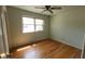 Light green bedroom with hardwood floors and natural light streaming through the window at 7629 Walton Dr, Indianapolis, IN 46214