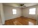 Empty bedroom with hardwood floors, ceiling fan and lots of natural light at 7629 Walton Dr, Indianapolis, IN 46214
