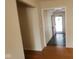 Hallway featuring hardwood floors and a glimpse of a pink door in the entryway at 7629 Walton Dr, Indianapolis, IN 46214