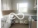 Bright kitchen featuring white cabinets, countertops, and modern appliances at 7629 Walton Dr, Indianapolis, IN 46214