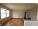 Open concept living room featuring large window, hardwood floors and entry to hallway at 7629 Walton Dr, Indianapolis, IN 46214