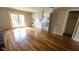 Open concept living room with sliding doors and an updated kitchen featuring white cabinets and modern appliances at 7629 Walton Dr, Indianapolis, IN 46214