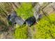 Overhead view of a home featuring a dark roof, surrounded by lush trees and natural landscaping at 8277 N Lasalle Rd, Morgantown, IN 46160