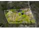 Aerial view showing property lines surrounding wooded lot with cozy house on lush land with green and brown trees at 8277 N Lasalle Rd, Morgantown, IN 46160