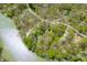 Aerial view of wooded neighborhood with homes and a long lake showing road and dock access at 8277 N Lasalle Rd, Morgantown, IN 46160