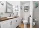 Clean bathroom featuring a white toilet and sink, with tiled walls and floors that make it easy to clean at 8277 N Lasalle Rd, Morgantown, IN 46160