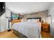 Cozy bedroom features a comfortable bed, patterned accent wall, hardwood floors, and ample natural light from the window at 8277 N Lasalle Rd, Morgantown, IN 46160