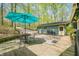 Outdoor deck with seating and an umbrella, perfect for relaxation amidst a serene, wooded backdrop at 8277 N Lasalle Rd, Morgantown, IN 46160