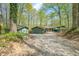 Long gravel driveway leading to charming home and multiple garages surrounded by trees at 8277 N Lasalle Rd, Morgantown, IN 46160