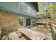 Large deck with stone and siding exterior and a wooden playset, perfect for outdoor enjoyment and entertaining at 8277 N Lasalle Rd, Morgantown, IN 46160