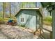 Cozy cottage exuding rustic charm, complemented by stone detailing and scenic woodland backdrop at 8277 N Lasalle Rd, Morgantown, IN 46160