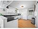 Bright kitchen with white cabinets, black countertops, and wooden floors at 8277 N Lasalle Rd, Morgantown, IN 46160