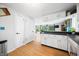 Bright kitchen featuring white cabinets, black countertops, and an open layout to the living area at 8277 N Lasalle Rd, Morgantown, IN 46160
