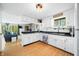 Bright kitchen features stainless appliances, white cabinetry, and an adjacent living area creating an open concept feel at 8277 N Lasalle Rd, Morgantown, IN 46160
