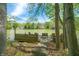 Lake view featuring a wooden dock with benches, set against a backdrop of serene water and lush greenery at 8277 N Lasalle Rd, Morgantown, IN 46160