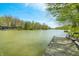 Picturesque lake view from a wooden dock with benches, offering a tranquil setting surrounded by trees at 8277 N Lasalle Rd, Morgantown, IN 46160