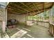 Covered patio with wooden deck, stone wall and outdoor seating at 8277 N Lasalle Rd, Morgantown, IN 46160