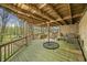 Covered patio with wooden deck, stone wall and outdoor seating at 8277 N Lasalle Rd, Morgantown, IN 46160