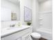 Bright bathroom with vanity, undermount sink, art, and a tub-shower combo with a white shower curtain at 8436 Paxton Dr, Brownsburg, IN 46112