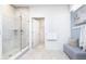 Bright bathroom with glass enclosed shower with gray tile, neutral paint, and a gray cushioned bench at 8436 Paxton Dr, Brownsburg, IN 46112