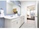 Bright bathroom featuring double vanity, quartz countertops, framed mirror, and open door to the bedroom at 8436 Paxton Dr, Brownsburg, IN 46112