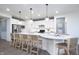 Bright kitchen with white cabinetry, a large island with seating, and pendant lighting at 8436 Paxton Dr, Brownsburg, IN 46112