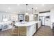Bright, open-concept kitchen featuring a large island with seating and stainless steel appliances at 8436 Paxton Dr, Brownsburg, IN 46112