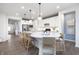 Spacious kitchen with a large island featuring pendant lighting, seating, and modern appliances at 8436 Paxton Dr, Brownsburg, IN 46112