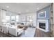 Bright living room features a fireplace, neutral decor and large windows at 8436 Paxton Dr, Brownsburg, IN 46112
