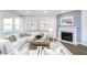 Bright living room features a fireplace, neutral decor, large windows and hardwood floors at 8436 Paxton Dr, Brownsburg, IN 46112
