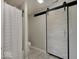 A bathroom is shown featuring a shower and a sliding barn door at 845 Blackberry Dr, Greenwood, IN 46143