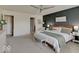 Well-lit main bedroom featuring soft carpet, board and batten accent wall, and modern furnishings at 845 Blackberry Dr, Greenwood, IN 46143