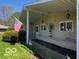 Charming covered front porch decorated with a lighthouse and an American flag at 8604 W Tulip Tree Dr, Muncie, IN 47304